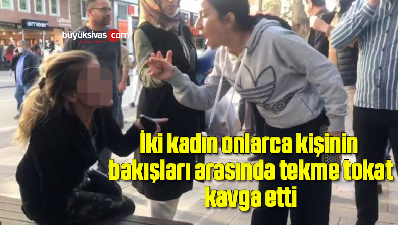 İki kadın onlarca kişinin bakışları arasında tekme tokat kavga etti