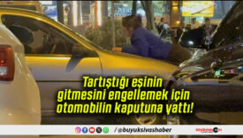 Tartıştığı eşinin gitmesini engellemek için otomobilin kaputuna yattı!